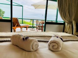 View from bed over balcony to the lagoon