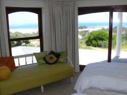 2nd sea-facing bedroom showing single sleeper couch which can be prepared as an extra bed for 3rd guest to share this bedroom