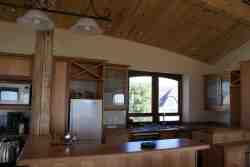 Open-plan kitchen, faces towards lounge, dining area and ocean