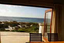 Dining area folding doors open on to first floor deck. Note open balustrade rails - children to be supervised.