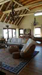 Open plan lounge and entertainment area under stunning double volume thatch and timber roof 