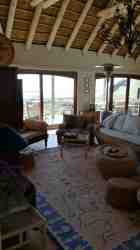 Lounge facing ocean, sliding and folding doors open on to first floor deck