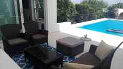 Infront of the flat large outside sitting area directly to the Pool.