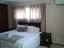 Spacious furnished room with Air conditioner, DSTV, internet Access (Wi-Fi) and tea/coffee table. Room comes with a King bed.