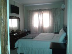 Spacious furnished room with Air conditioner, DSTV, internet Access (Wi-Fi) and tea/coffee table. Room comes with a King bed.