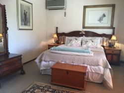 The Yellow Wood Room with queen size bed, bathroom ensuite with bath, shower, toilet and basin. Airconditioner, WiFi, DSTV, work station desk