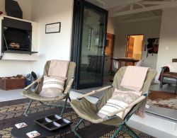 Built in braai on enclosed veranda behind stacking doors