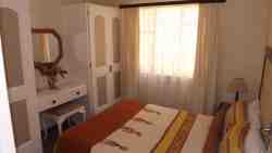 Room 7: Small cottage with 2 bedrooms. The first has a double bed and the other a single bed. There is a lounge and en-suite shower.