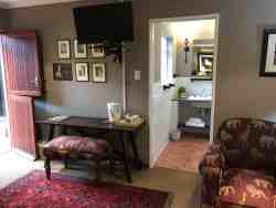 A luxurious and spacious room with two 3/4 beds, a side table and reading lamps.  This room is accessed from the patio and very close to one of the parking areas.  Although close to the Queens dining room where breakfast is served in the morning, this suite is private. The room is beautifully decorated and an interesting collection of art grace the walls. The en-suite bathroom has a bath and the basin is fitted into a spacious vanity top. There is also a comfortable seating area and a writing area in this room.
•	Free WiFi
•	Air Conditioning
•	Electric Blankets in winter
•	Coffee/ Tea making facilities
•	Secure parking
