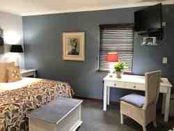 These are our executive suites, situated in the shady gardens and close to the parking area.  The rooms also have a garden view and is accessed from the garden.  Paved walkways lead to the dining room. The suites are elegant and beautifully dressed.  The beds can either be king size or twin, whichever the preference. They offer comfortable seating and a writing desk. The bathrooms are en-suite with both bath and shower and a vanity top.

•	Free WiFi
•	Air Conditioning
•	Electric Blankets in winter
•	Coffee/ Tea making facilities
•	Secure parking
