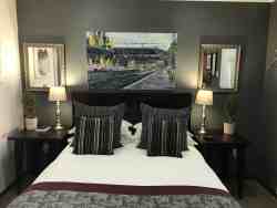 These rooms are elegant and stylish. These suites consist of a queen size bed with bedside tables and reading lamps. The en-suite bathrooms are complete with a shower and/or bath & shower, as well as a comfortable vanity top. The seating areas have comfortable chairs and a writing desk. The rooms are privately accessed from the beautiful shaded gardens, and situated close to the parking areas. Paved walkways lead to the dining room Queens, where breakfast is served in the mornings.   •	Free WiFi •	Air Conditioning •	Electric Blankets in winter •	Coffee/ Tea making facilities •	Secure parking