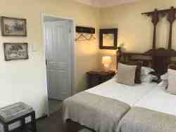 Luxurious and spacious rooms with twin beds, side tables and reading lamps.  These rooms are very close to the parking areas.  The suites are very private and have views of the garden. The rooms are beautifully decorated with an interesting collection of art that grace the walls. The en-suite bathrooms have a bath and/or a shower & bath, and the basins are fitted into spacious vanity tops. These suites have comfortable seating areas, as well as a writing desk. •	Free WiFi •	Air Conditioning •	Electric Blankets in winter •	Coffee/ Tea making facilities •	Secure parking