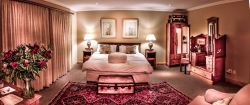 King Size bed with Victorian Ball and claw bath within the room
