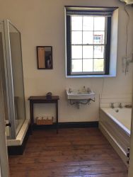The spacious bathroom has both a shower and a bath