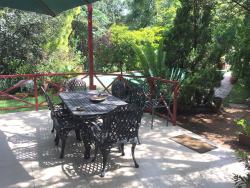 Our Patio by the Pool, perfect place to relax, have breakfast, or just take in the nature of our lush garden.