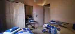 Second bedroom with two single beds and wardrobe