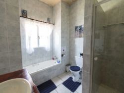 There are two bathrooms in the house, each of which has a bath, shower and toilet
