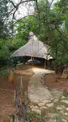 Log Cabin 1's Jacuzzi  is nestled among the trees