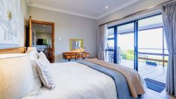 Main bedroom with Queen bed and sea views