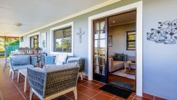Outdoor seating and dining area with full sea views