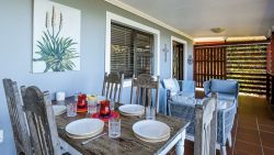 Outdoor seating and dining area with full sea views
