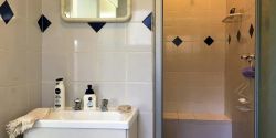En-suite bathroom with seat in shower 