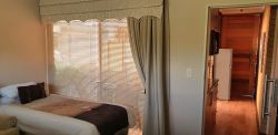 Queen Suite with Private Patio - Living Room with extra bed