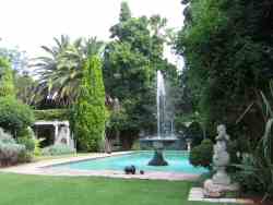 Swimming pool and fountain with Gazebo in the background