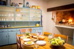 Cottage 1: Fully equipped kitchen with fireplace inside of the kitchen