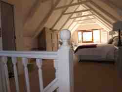 view of loft room showing a glimpse of slipper bath